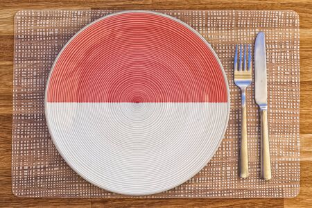 Dinner plate with the flag of Monaco on it for your international food and drink concepts.の写真素材