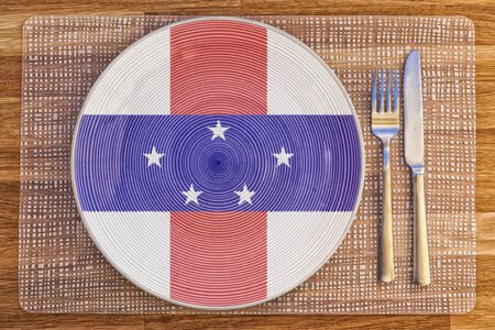 Dinner plate with the flag of Netherlands Antilles on it for your international food and drink concepts.の写真素材