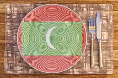 Dinner plate with the flag of Maldives on it for your international food and drink concepts.の写真素材