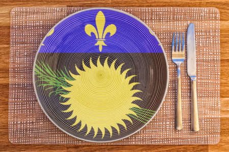 Dinner plate with the flag of Guadeloupe on it for your international food and drink concepts.の写真素材
