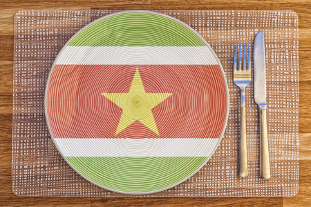 Dinner plate with the flag of Suriname on it for your international food and drink concepts.の写真素材
