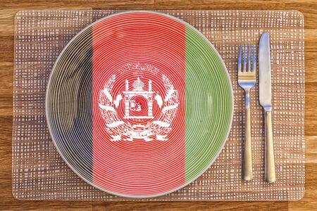 Dinner plate with the flag of Afghanistan on it for your international food and drink concepts.の写真素材