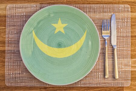 Dinner plate with the flag of Mauritania on it for your international food and drink concepts.の写真素材