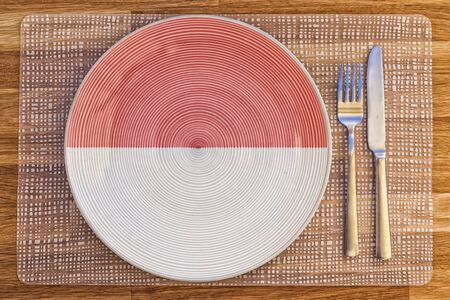 Dinner plate with the flag of Indonesia on it for your international food and drink concepts.の写真素材