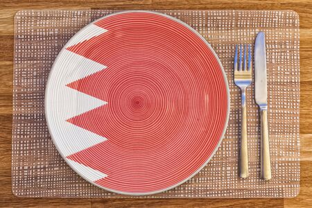 Dinner plate with the flag of Bahrain on it for your international food and drink concepts.の写真素材