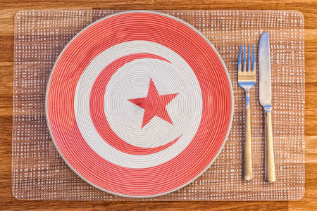 Dinner plate with the flag of Tunisia on it for your international food and drink concepts.の写真素材