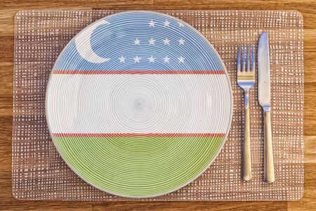 Dinner plate with the flag of Uzbekistan on it for your international food and drink concepts.の写真素材