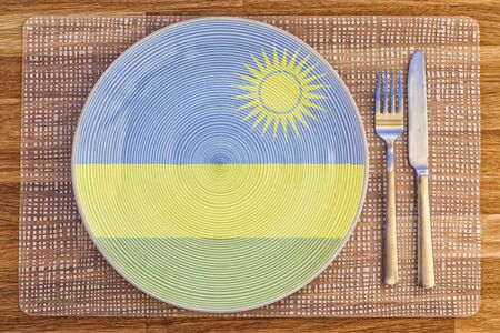 Dinner plate with the flag of Rwanda on it for your international food and drink concepts.の写真素材