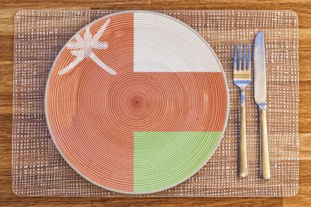 Dinner plate with the flag of Oman on it for your international food and drink concepts.の写真素材