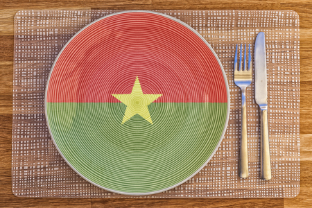 Dinner plate with the flag of Burkina Faso on it for your international food and drink concepts.の写真素材