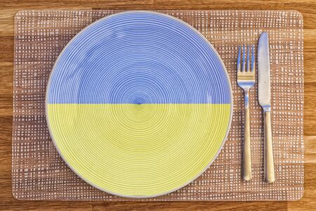Dinner plate with the flag of Uganda on it for your international food and drink concepts.の写真素材