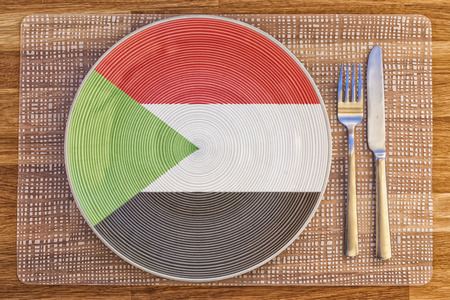 Dinner plate with the flag of Sudan on it for your international food and drink concepts.の写真素材