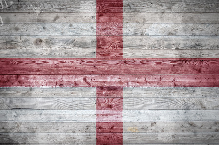 A vignetted background image of the flag of England painted onto wooden boards of a wall or floor.の写真素材