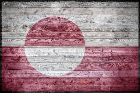 A vignetted background image of the flag of Greenland painted onto wooden boards of a wall or floor.の写真素材