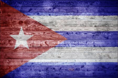 A vignetted background image of the flag of Cuba painted onto wooden boards of a wall or floor.の写真素材