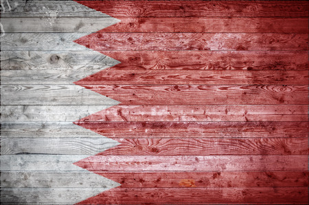 A vignetted background image of the flag of Bahrain painted onto wooden boards of a wall or floor.の写真素材