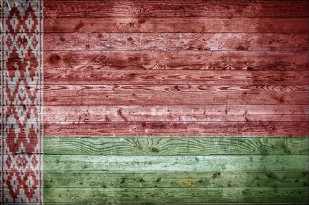 A vignetted background image of the flag of Belarus painted onto wooden boards of a wall or floor.の写真素材
