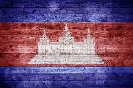 A vignetted background image of the flag of Cambodia painted onto wooden boards of a wall or floor.の写真素材