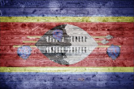 A vignetted background image of the flag of Swaziland onto wooden boards of a wall or floor.の写真素材