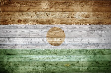 A vignetted background image of the flag of Niger onto wooden boards of a wall or floor.の写真素材
