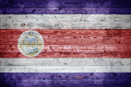A vignetted background image of the flag of Costa Rica painted onto wooden boards of a wall or floor.の写真素材