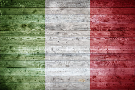 A vignetted background image of the flag of Italy painted onto wooden boards of a wall or floor.の写真素材