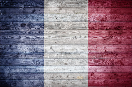A vignetted background image of the flag of France painted onto wooden boards of a wall or floor.の写真素材