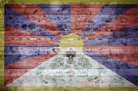 A vignetted background image of the flag of Tibet onto wooden boards of a wall or floor.の写真素材