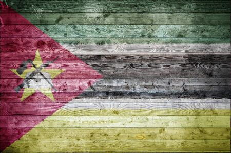 A vignetted background image of the flag of Mozambique painted onto wooden boards of a wall or floor.の写真素材