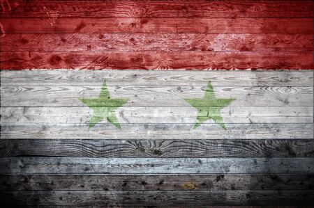 A vignetted background image of the flag of Syria onto wooden boards of a wall or floor.の写真素材