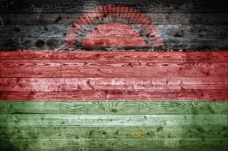 A vignetted background image of the flag of Malawi painted onto wooden boards of a wall or floor.の写真素材