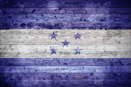 A vignetted background image of the flag of Honduras painted onto wooden boards of a wall or floor.の写真素材