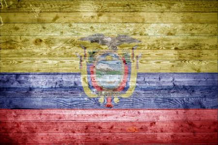 A vignetted background image of the flag of Ecuador painted onto wooden boards of a wall or floor.の写真素材