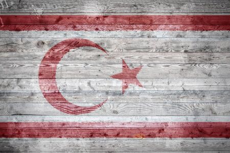 A vignetted background image of the flag of Northern Cyprus onto wooden boards of a wall or floor.の写真素材
