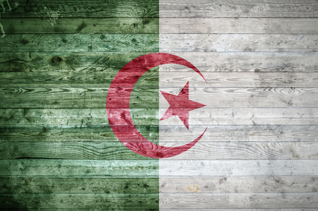 A vignetted background image of the flag of Algeria painted onto wooden boards of a wall or floor.の写真素材
