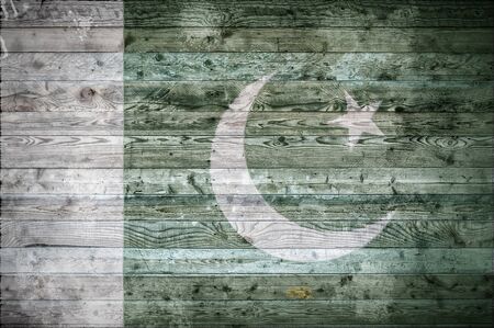 A vignetted background image of the flag of Pakistan onto wooden boards of a wall or floor.の写真素材