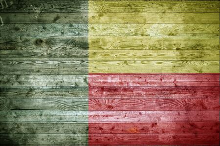 A vignetted background image of the flag of Benin painted onto wooden boards of a wall or floor.の写真素材