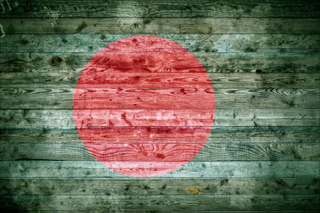 A vignetted background image of the flag of Bangladesh painted onto wooden boards of a wall or floor.の写真素材