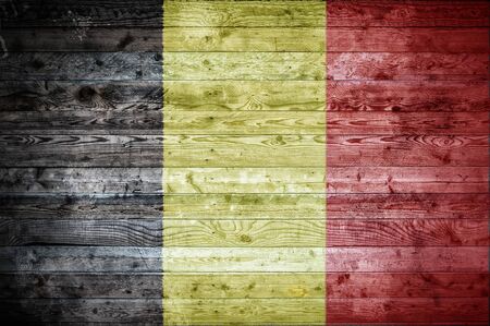 A vignetted background image of the flag of Belgium painted onto wooden boards of a wall or floor.の写真素材