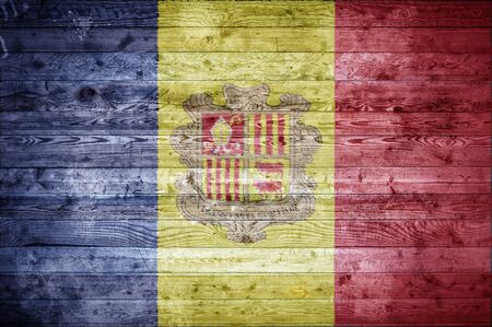 A vignetted background image of the flag of Andorra painted onto wooden boards of a wall or floor.の写真素材