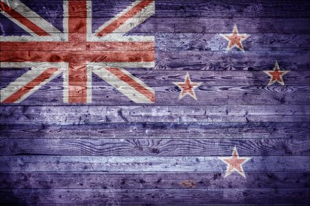 A vignetted background image of the flag of New Zealand onto wooden boards of a wall or floor.の写真素材