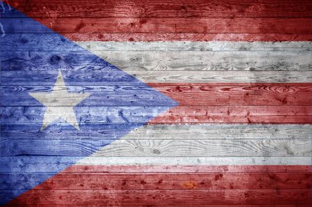 A vignetted background image of the flag of Puerto Rico onto wooden boards of a wall or floor.の写真素材