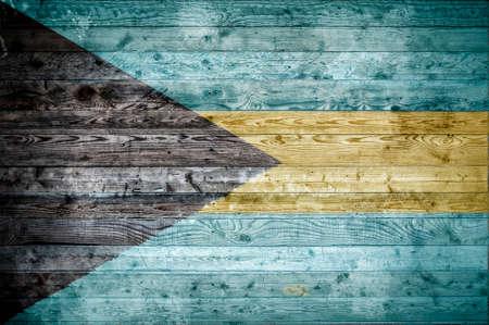 A vignetted background image of the flag of Bahamas painted onto wooden boards of a wall or floor.の写真素材