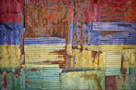 An abstract background image of the flag of Mauritius painted on to rusty corrugated iron sheets overlapping to form a wall or fence.の写真素材