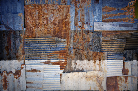 An abstract background image of the flag of Estonia painted on to rusty corrugated iron sheets...
