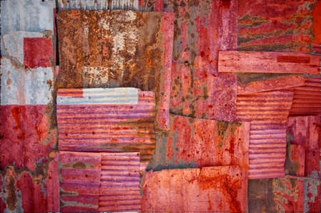 An abstract background image of the flag of Tonga painted on to rusty corrugated iron sheets...