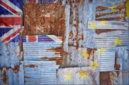 An abstract background image of the flag of Tuvalu painted on to rusty corrugated iron sheets overlapping to form a wall or fence.の写真素材