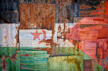 An abstract background image of the flag of Western Sahara painted on to rusty corrugated iron sheets overlapping to form a wall or fence.の写真素材