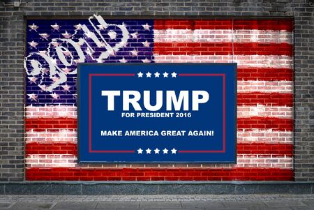 HELSINGBORG, SWEDEN - March 09, 2016: Donald Trumps 2016 presidential campaign poster on a billboard with American flag painted on the wall behind it.のeditorial素材