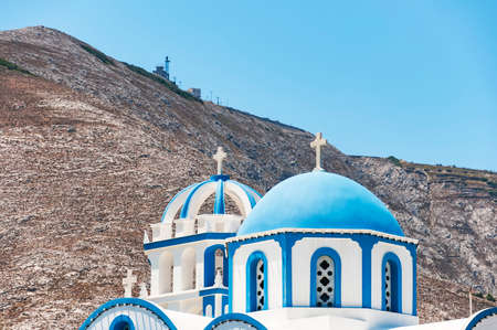 One of the many blue domed churches that adorn the greek island of santorini.の写真素材